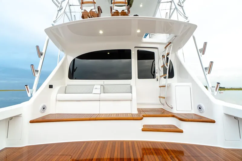 Slide: The Image of 2025 Viking 54 yacht with teak deck and white seating area. - 7