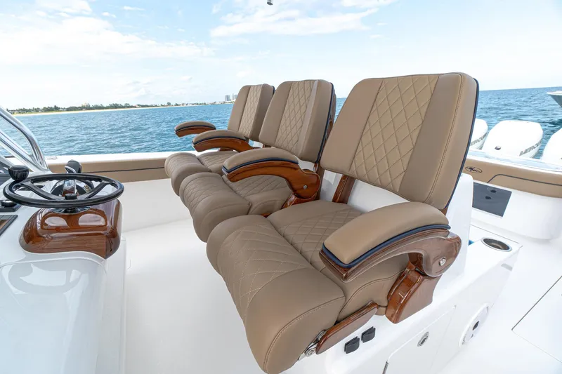 Slide: The Image of Luxurious seating on the 2025 Valhalla Boatworks 41 model, featuring tan leather and wooden accents. - 6