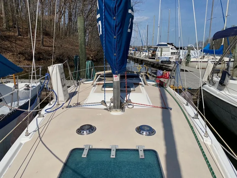 Slide: The Image of Sailboat Newport 27, 1988 model, docked at marina with clear sky. - 1