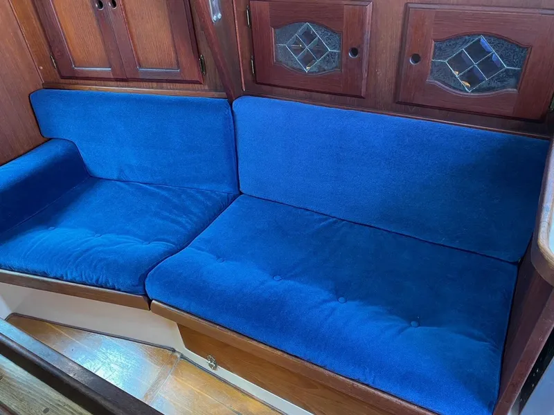 Slide: The Image of Blue cushioned seating in a 1988 Newport 27 boat interior. - 14