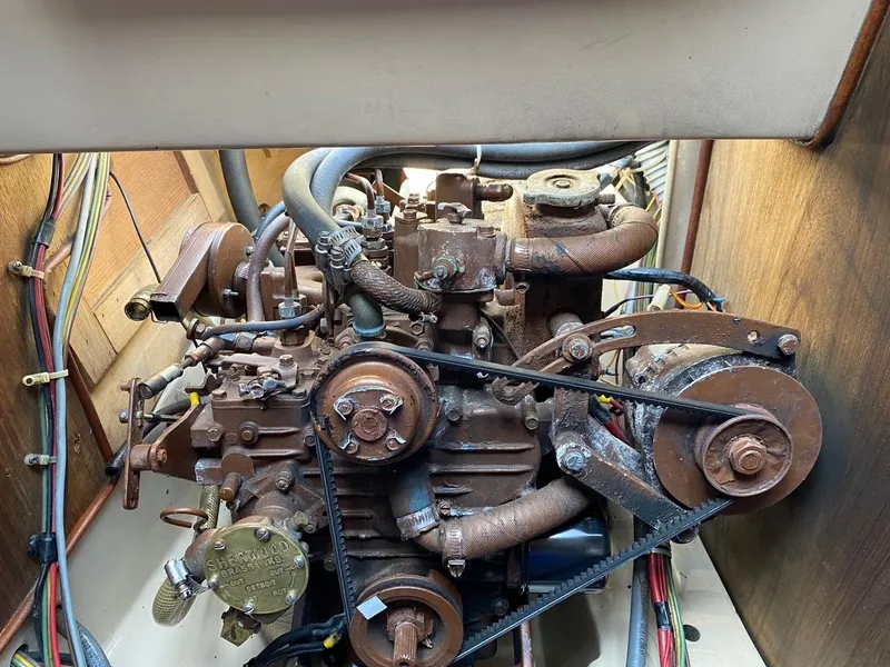 Slide: The Image of Engine compartment of a 1988 Newport 27 sailboat, showcasing mechanical components and wiring. - 2