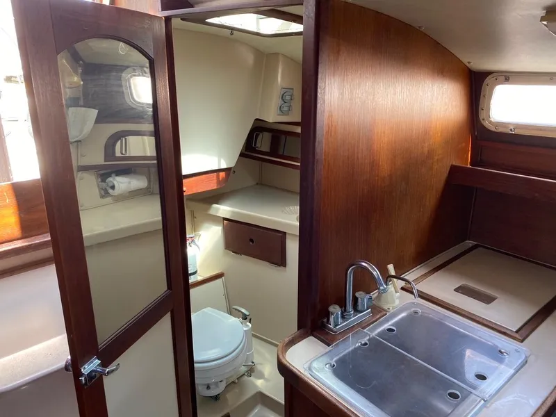 Slide: The Image of Interior of 1988 Newport 27 sailboat with compact kitchen and bathroom. - 7