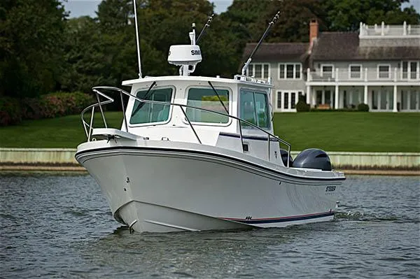 The Image of 2026 Steiger Craft 28 Miami boat cruising near a waterfront property. - 2
