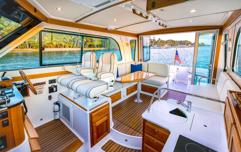 Slide: The Image of Interior of 2025 Back Cove 372 yacht with luxurious seating and scenic water view. - 12