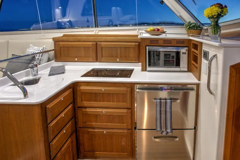 Slide: The Image of Modern kitchen in 2025 Back Cove 372 yacht with wood cabinetry and stainless steel appliances. - 17