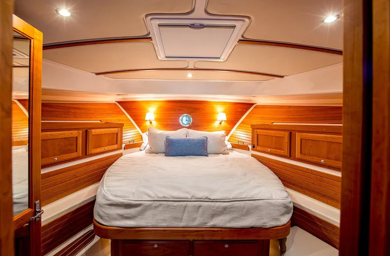 Slide: The Image of Luxurious cabin interior of 2025 Back Cove 372 yacht with cozy bed and wooden accents. - 18