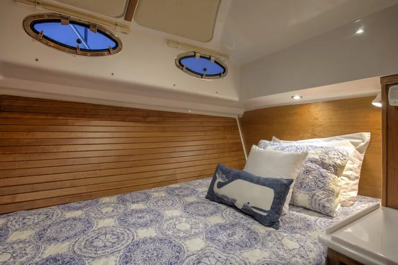 Slide: The Image of Cozy cabin interior of 2025 Back Cove 372 yacht with nautical-themed bedding. - 19