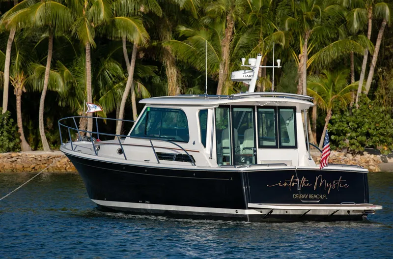 Slide: The Image of 2025 Back Cove 372 boat cruising near palm trees. - 7