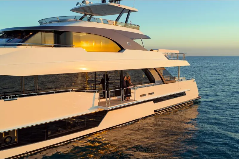 Slide: The Image of 2023 Ocean Alexander 37L luxury yacht cruising at sunset. - 11