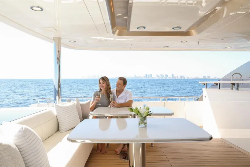 Slide: The Image of Couple enjoying drinks on the deck of a 2023 Ocean Alexander 37L yacht. - 24