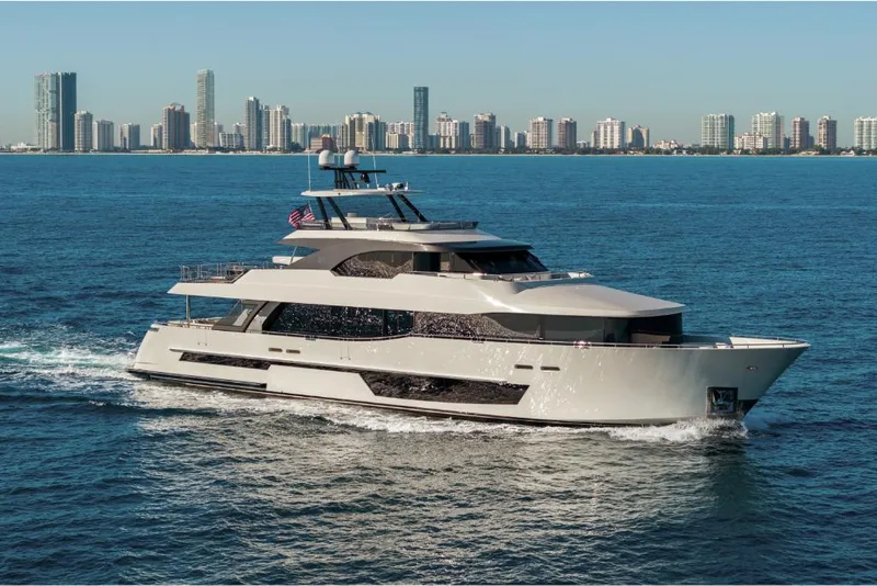 Slide: The Image of 2023 Ocean Alexander 37L yacht cruising near a city skyline. - 3