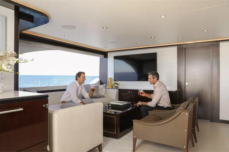 Slide: The Image of Luxurious interior of 2023 Ocean Alexander 37L yacht with two men enjoying drinks. - 30
