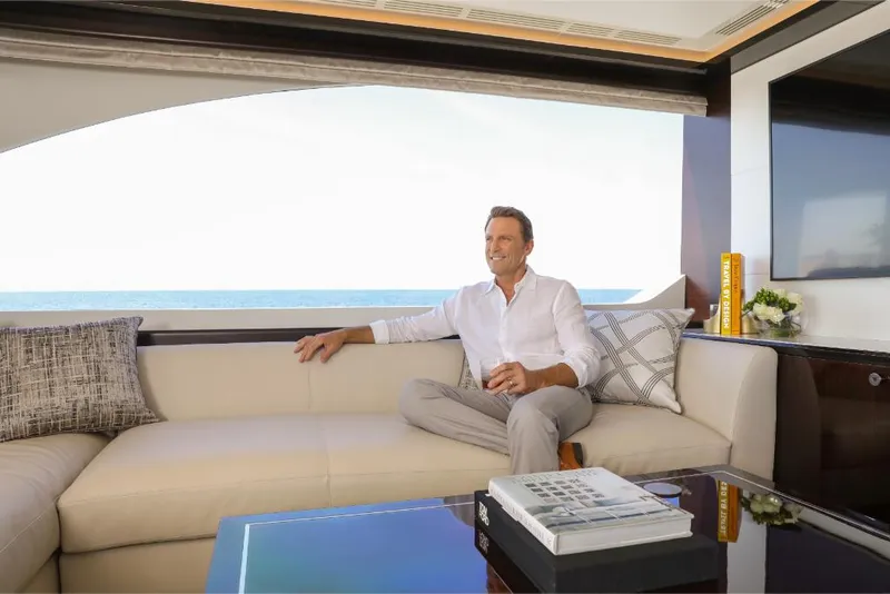Slide: The Image of Man relaxing in the luxurious interior of a 2023 Ocean Alexander 37L yacht. - 33