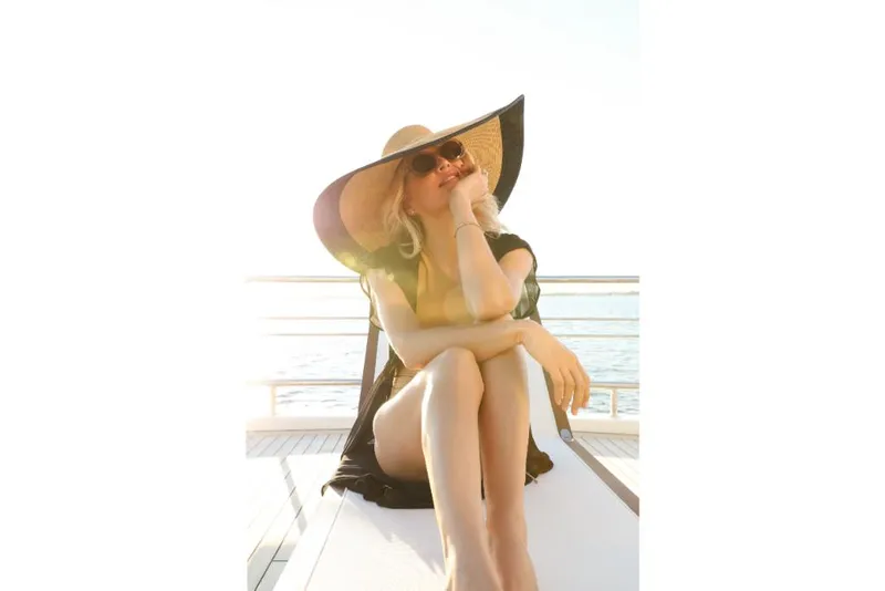 Slide: The Image of Woman relaxing on Ocean Alexander 37L yacht, 2023 model, wearing a sunhat and sunglasses. - 41