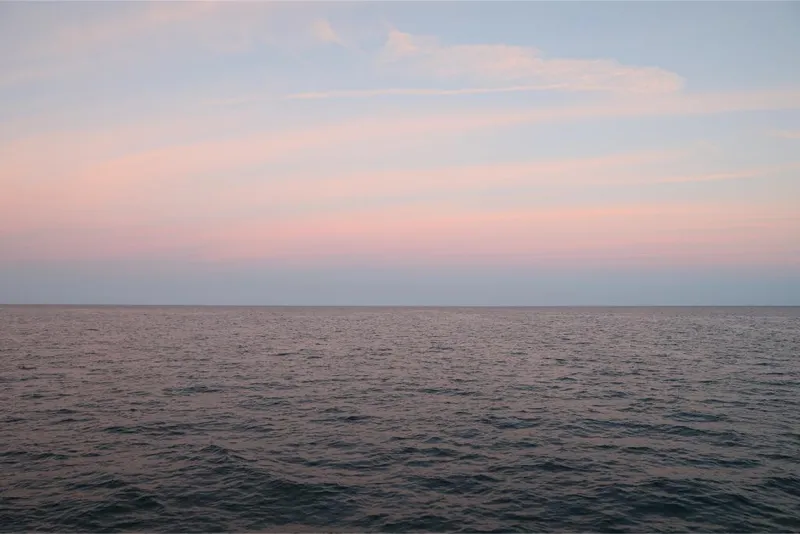 Slide: The Image of Ocean Alexander 37L 2023 model cruising at sunset on calm waters. - 43