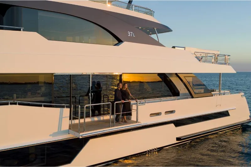 Slide: The Image of 2023 Ocean Alexander 37L yacht at sunset with people on deck. - 9