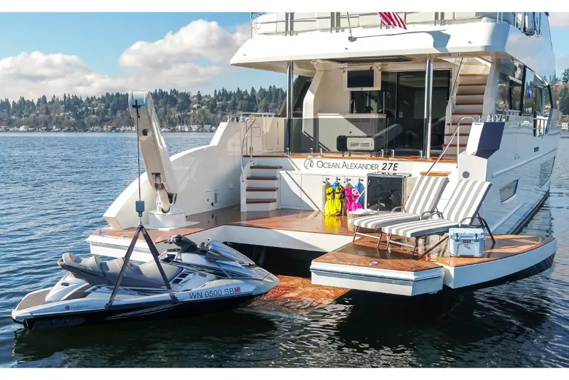 Slide: The Image of 2023 Ocean Alexander 27E yacht with jet ski on water. - 10
