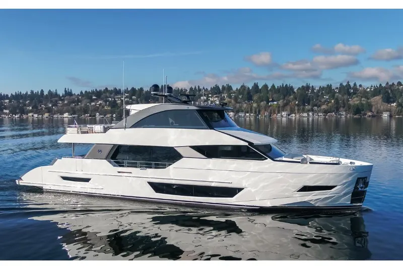 Slide: The Image of 2023 Ocean Alexander 27E luxury yacht on a serene lake. - 2