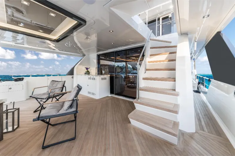 Slide: The Image of Luxury deck of 2023 Ocean Alexander 27E yacht with seating and staircase. - 21