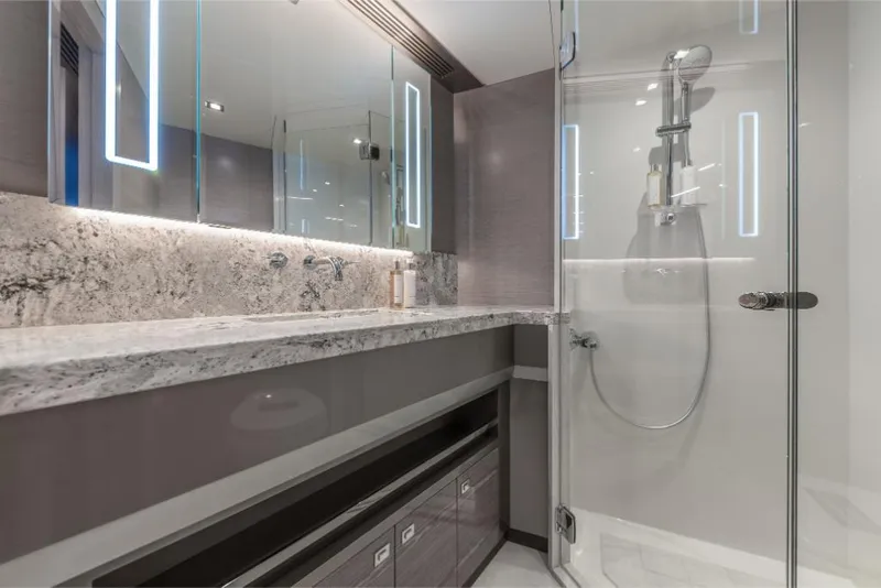 Slide: The Image of Luxury bathroom in 2023 Ocean Alexander 27E yacht with modern fixtures and marble countertop. - 24