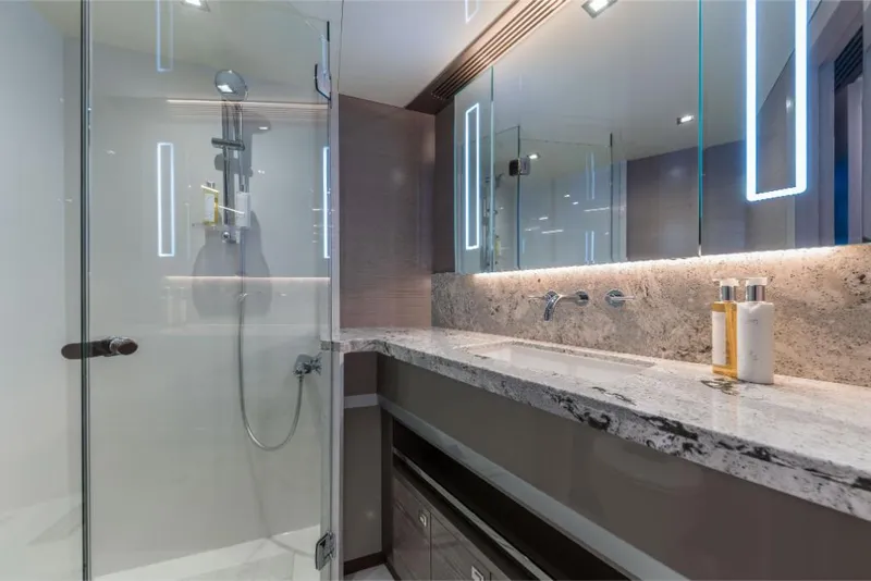 Slide: The Image of Modern bathroom in 2023 Ocean Alexander 27E yacht with glass shower and marble countertop. - 26