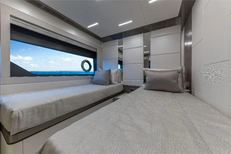 Slide: The Image of Modern bedroom interior of 2023 Ocean Alexander 27E yacht with twin beds and ocean view. - 27
