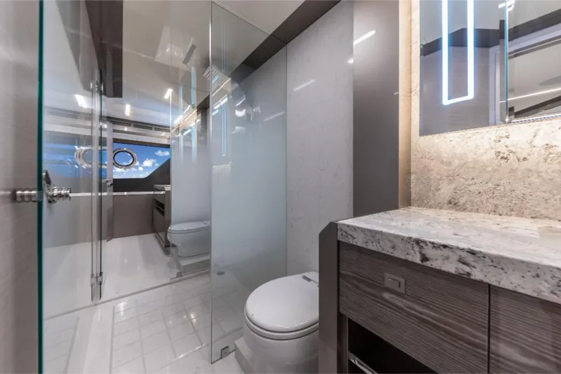 Slide: The Image of Modern bathroom on the 2023 Ocean Alexander 27E yacht with sleek design and glass partitions. - 46