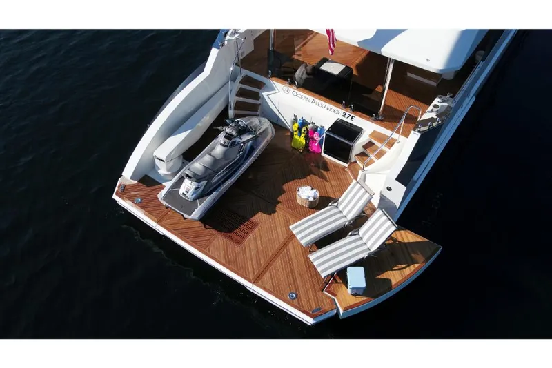 Slide: The Image of Aerial view of 2023 Ocean Alexander 27E yacht with jet ski and lounge chairs. - 7