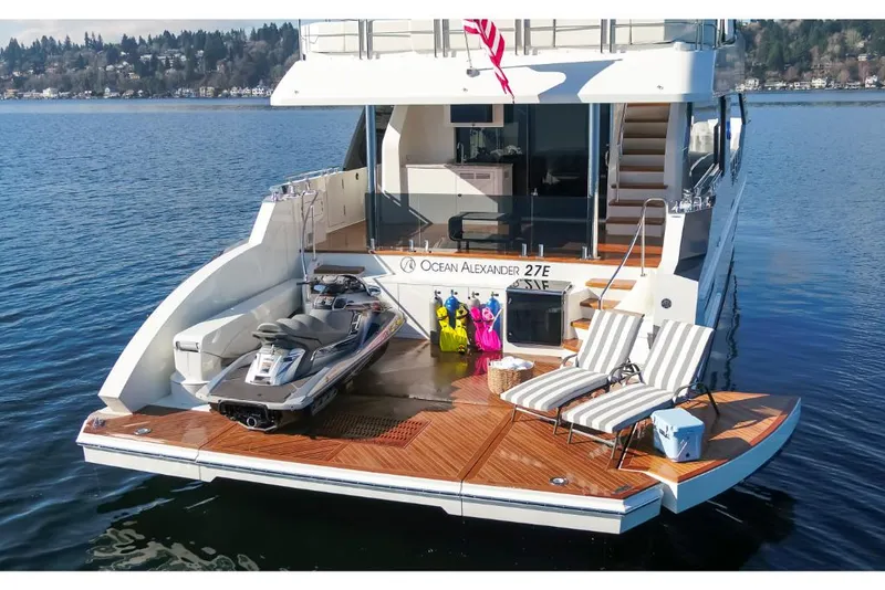 Slide: The Image of 2023 Ocean Alexander 27E yacht with jet ski and lounge chairs on the deck. - 9