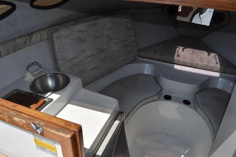 Slide: The Image of 1991 Sea Sprite 225 boat interior with sink and seating area. - 10