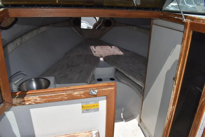 Slide: The Image of 1991 Sea Sprite 225 boat cabin interior with sink and seating area. - 11