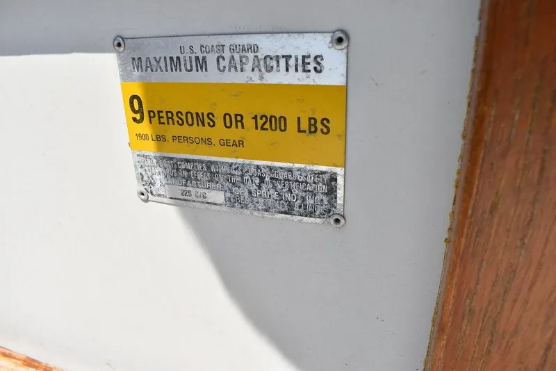 Slide: The Image of 1991 Sea Sprite 225 capacity plate, 9 persons or 1200 lbs, U.S. Coast Guard compliant. - 12