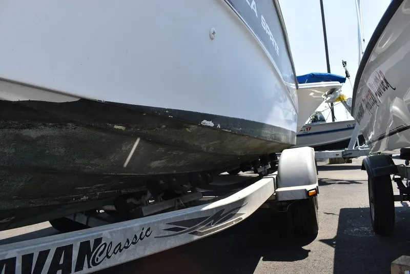 Slide: The Image of 1991 Sea Sprite 225 boat on a trailer, close-up view of the hull. - 34