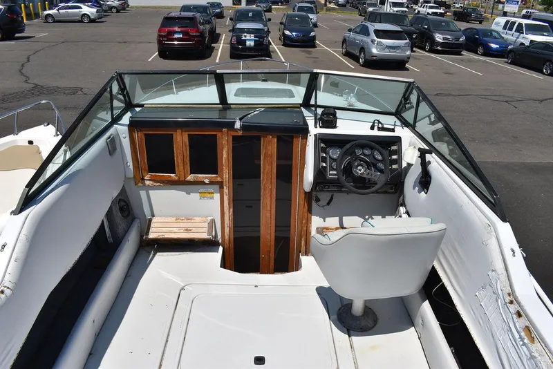 Slide: The Image of 1991 Sea Sprite 225 boat interior with steering wheel and dashboard. - 7