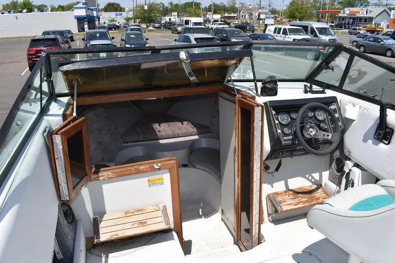 Slide: The Image of 1991 Sea Sprite 225 boat interior with steering wheel and cabin entrance. - 9