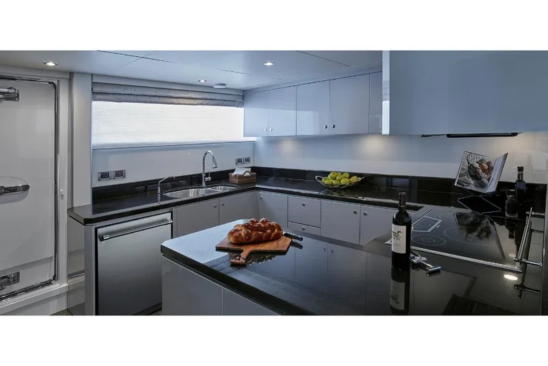 Slide: The Image of Modern kitchen in 2023 Ocean Alexander 32L yacht with sleek black countertops. - 24