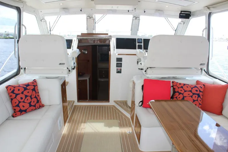 Slide: The Image of Interior of 2023 MJM 53z yacht with white seating and colorful cushions. - 10