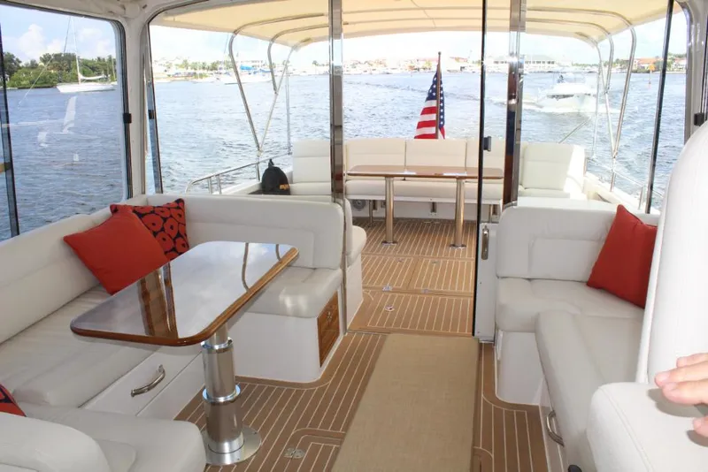 Slide: The Image of Luxurious interior of 2023 MJM 53z yacht with white seating and wooden table. - 11