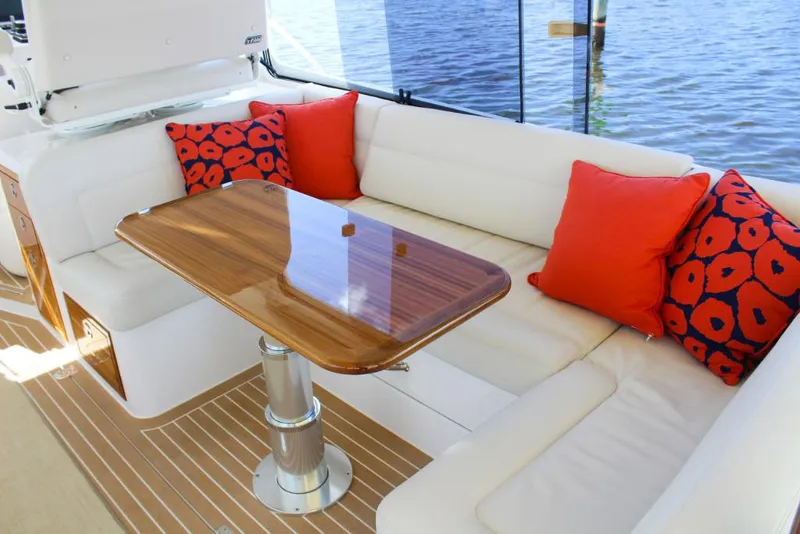 Slide: The Image of Luxurious seating area on the 2023 MJM 53z yacht with vibrant red cushions. - 12
