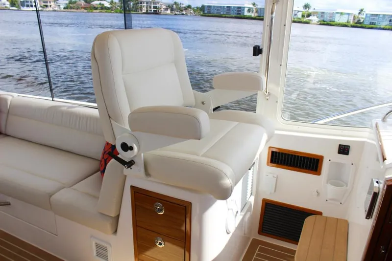 Slide: The Image of Captain's chair on the 2023 MJM 53z yacht with waterfront view. - 14
