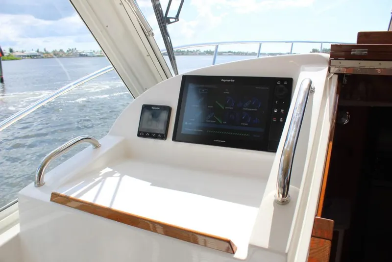 Slide: The Image of 2023 MJM 53z boat helm with navigation display and controls. - 16