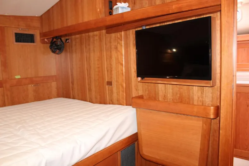Slide: The Image of 2023 MJM 53z yacht interior cabin with bed and mounted TV. - 21