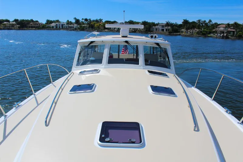 Slide: The Image of 2023 MJM 53z yacht on a sunny day, cruising on a serene lake. - 3