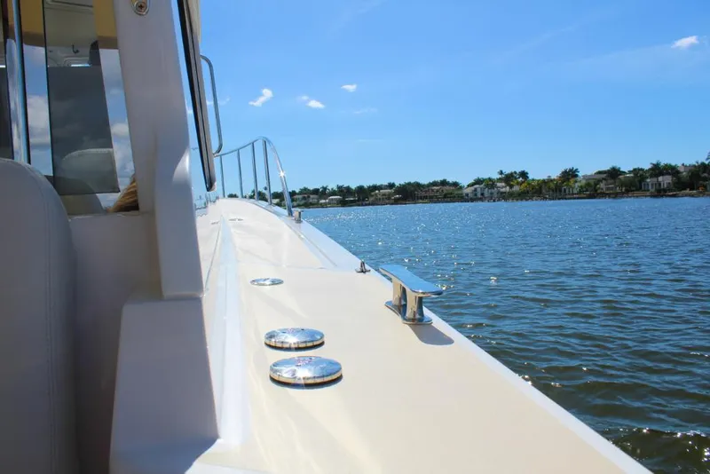 Slide: The Image of Side view of 2023 MJM 53z boat cruising on a sunny day. - 5