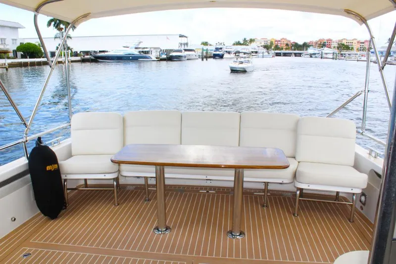 Slide: The Image of MJM 53z 2023 model yacht with spacious seating and waterfront view. - 6