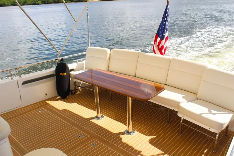 Slide: The Image of 2023 MJM 53z yacht deck with seating and American flag. - 8