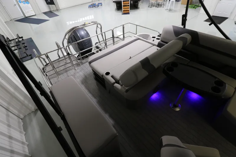 Slide: The Image of 2023 Sylvan L5 CLZ pontoon boat interior with seating and ambient lighting. - 14