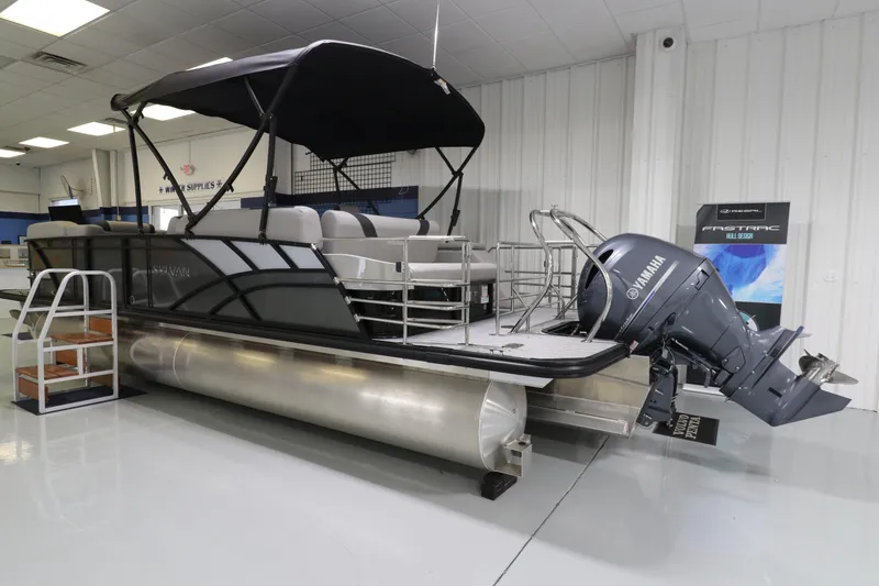 Slide: The Image of 2023 Sylvan L5 CLZ pontoon boat with Yamaha outboard motor in showroom. - 2