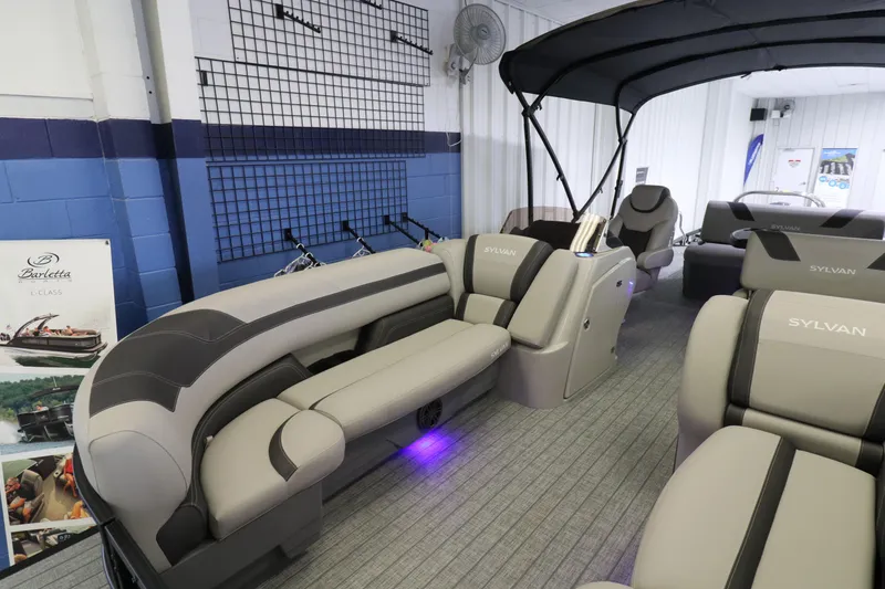 Slide: The Image of 2023 Sylvan L5 CLZ pontoon boat interior with plush seating and canopy. - 4