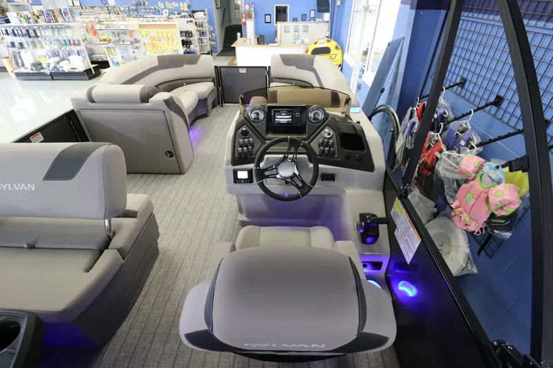 Slide: The Image of 2023 Sylvan L5 CLZ pontoon boat interior with modern helm and spacious seating. - 9